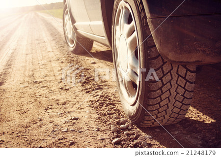 car tire on dirt road car tire on dirt road 21248179