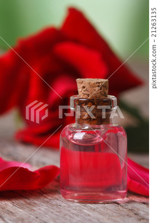 rose oil on a background of red roses. vertical rose oil on a background of red roses. vertical 21263135