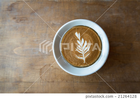 glass of latte coffee on wooden table glass of latte coffee on wooden table 21264128