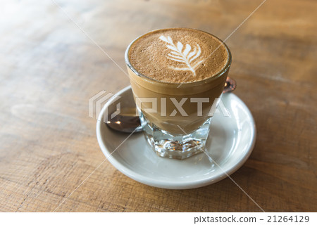 glass of latte coffee on wooden table glass of latte coffee on wooden table 21264129