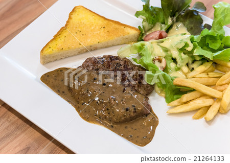 Grilled steak, French fries and vegetables Grilled steak, French fries and vegetables 21264133