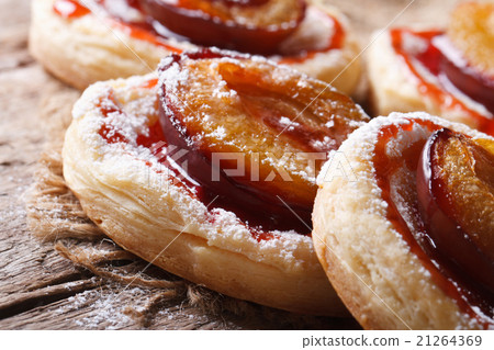 Pies of puff pastry with plums macro 21264369