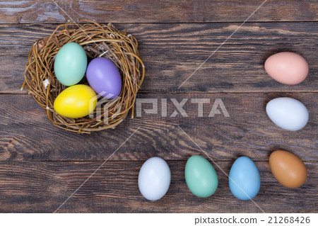 Easter colorful eggs in bird nest on wood 21268426