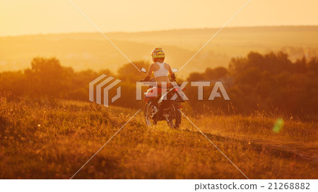 Woman biker in sunset, female motorcycle. 21268882