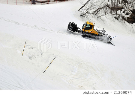 Yellow ratrak works in mountains 21269074
