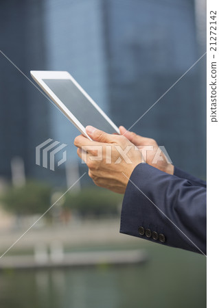 Close-up view of Asian businessman using digital tablet. 21272142