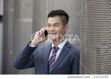 Asian business man talking on his smart phone. 21272145