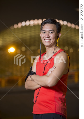 Sporty Asian man outdoors in urban city at night 21272172