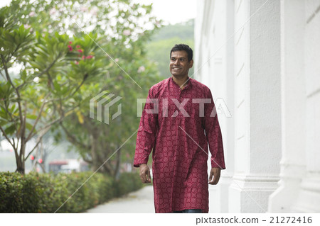 Happy indian man walking outdoors. Happy indian man walking outdoors. 21272416