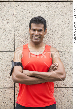 Sporty Indian man resting after urban run. Sporty Indian man resting after urban run. 21272465