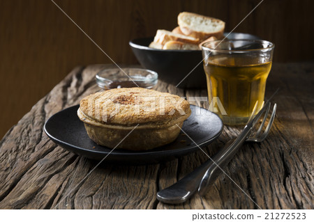 Traditional British meat pie on a rustic table. Traditional British meat pie on a rustic table. 21272523