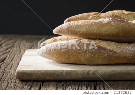 Bread loaves on an old rustic wooden table. 21272622