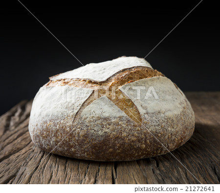 Sourdough loaf of bread on a rustic wood table. 21272641