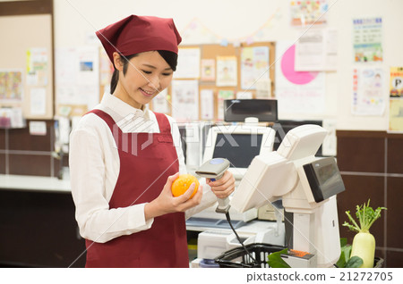 A woman working at super cash register A woman working at super cash register 21272705