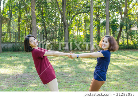 Two Asian woman doing exercise in park Two Asian woman doing exercise in park 21282053