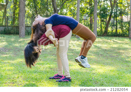 Two Asian woman doing exercise in park Two Asian woman doing exercise in park 21282054