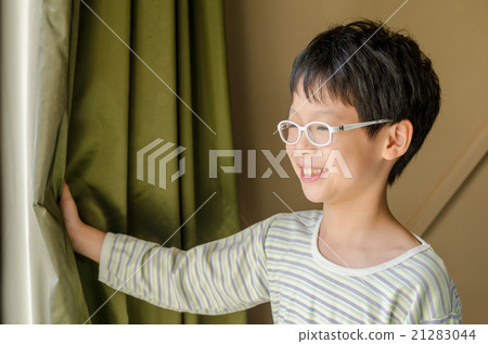 Young Asian boy open curtain and smile Young Asian boy open curtain and smile 21283044