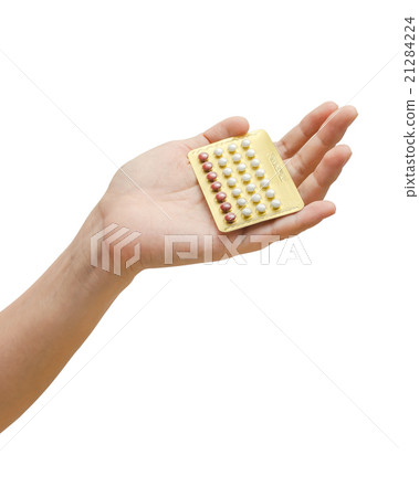 Woman hand holding contraceptives over white Woman hand holding contraceptives over white 21284224