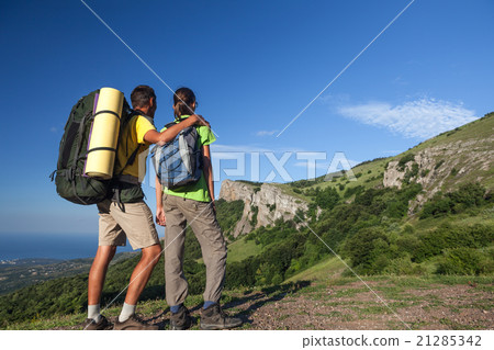 Two backpackers on top of a mountain Two backpackers on top of a mountain 21285342