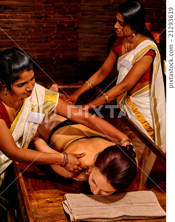 Woman having massage with pouch of rice. Woman having massage with pouch of rice. 21293619