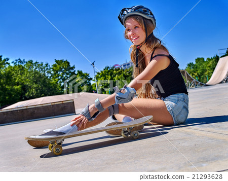 Sport girl with injury near her skateboard outdoor 21293628