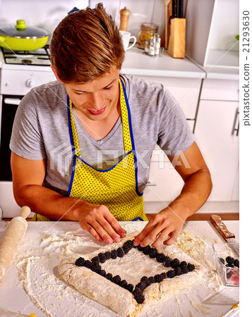 Man baking cookies in the oven Man baking cookies in the oven 21293630