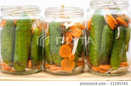 Pickled cucumbers in jars isolated on white 21295343
