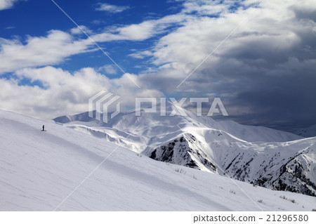 Ski slope in evening and storm clouds 21296580