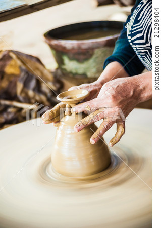 Closeup view of hands of an old asian potter Closeup view of hands of an old asian potter 21298404
