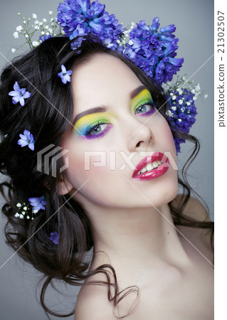 Beauty young woman with flowers and make up close 21302507