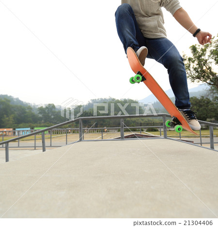 young skateboarder skateboarding at skatepark 21304406