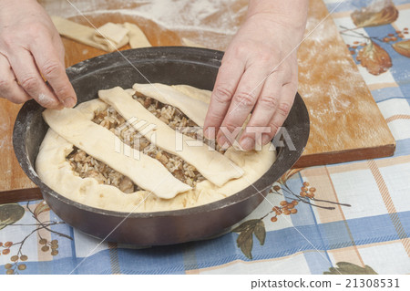 Raw dough with filling in black metal baking form Raw dough with filling in black metal baking form 21308531