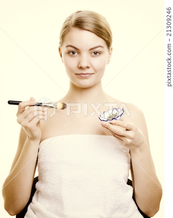 Skin care. Woman applying clay mask on face. Spa. 21309246