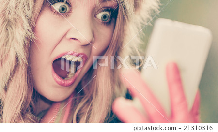 Scared afraid woman talking on mobile phone. Scared afraid woman talking on mobile phone. 21310316