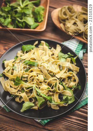 Cooked tagliatelle on a plate Cooked tagliatelle on a plate 21310329