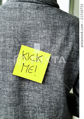 man with a paper with the text kick me in his back 21310733