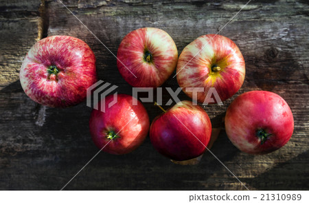 red apples on the old scratched board 21310989