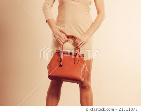 elegant woman holds brown handbag elegant woman holds brown handbag 21311073