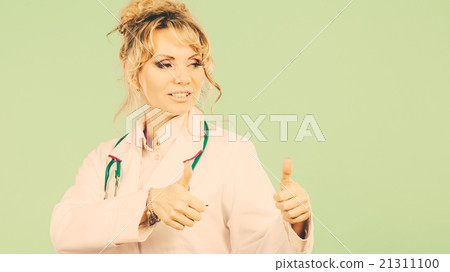 Female doctor showing thumb up. 21311100