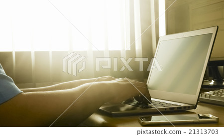 a man working from on his laptop computer  21313703