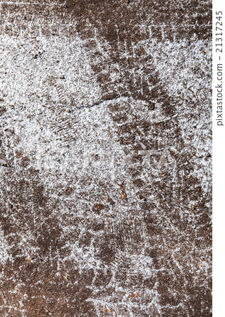 Tire trace in snow-covered road 21317245