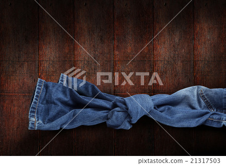 Jeans knot on wooden background Jeans knot on wooden background 21317503