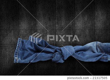 Jeans knot on wooden background Jeans knot on wooden background 21317505