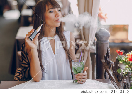 girn in cafe with E-Cigarette 21318330