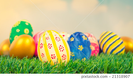 Easter Eggs on Fresh Green Grass over blue sky ( Filtered image Easter Eggs on Fresh Green Grass over blue sky ( Filtered image 21318907