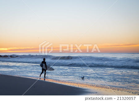 Surfer about to paddle out 21320057