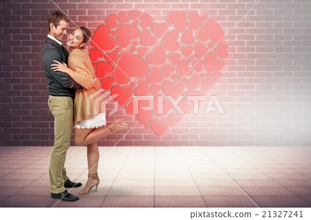 Composite image of full length of romantic couple hugging Composite image of full length of romantic couple hugging 21327241