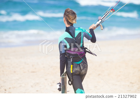 Female kiteboarder with kiteboarding equipment. Female kiteboarder with kiteboarding equipment. 21327902