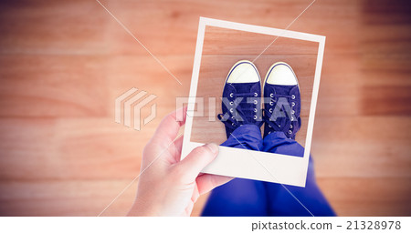 Composite image of hand holding polaroid picture Composite image of hand holding polaroid picture 21328978