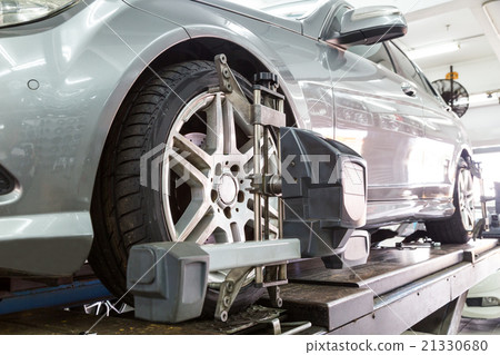 Tire clamped with aligner undergoing wheel align 21330680